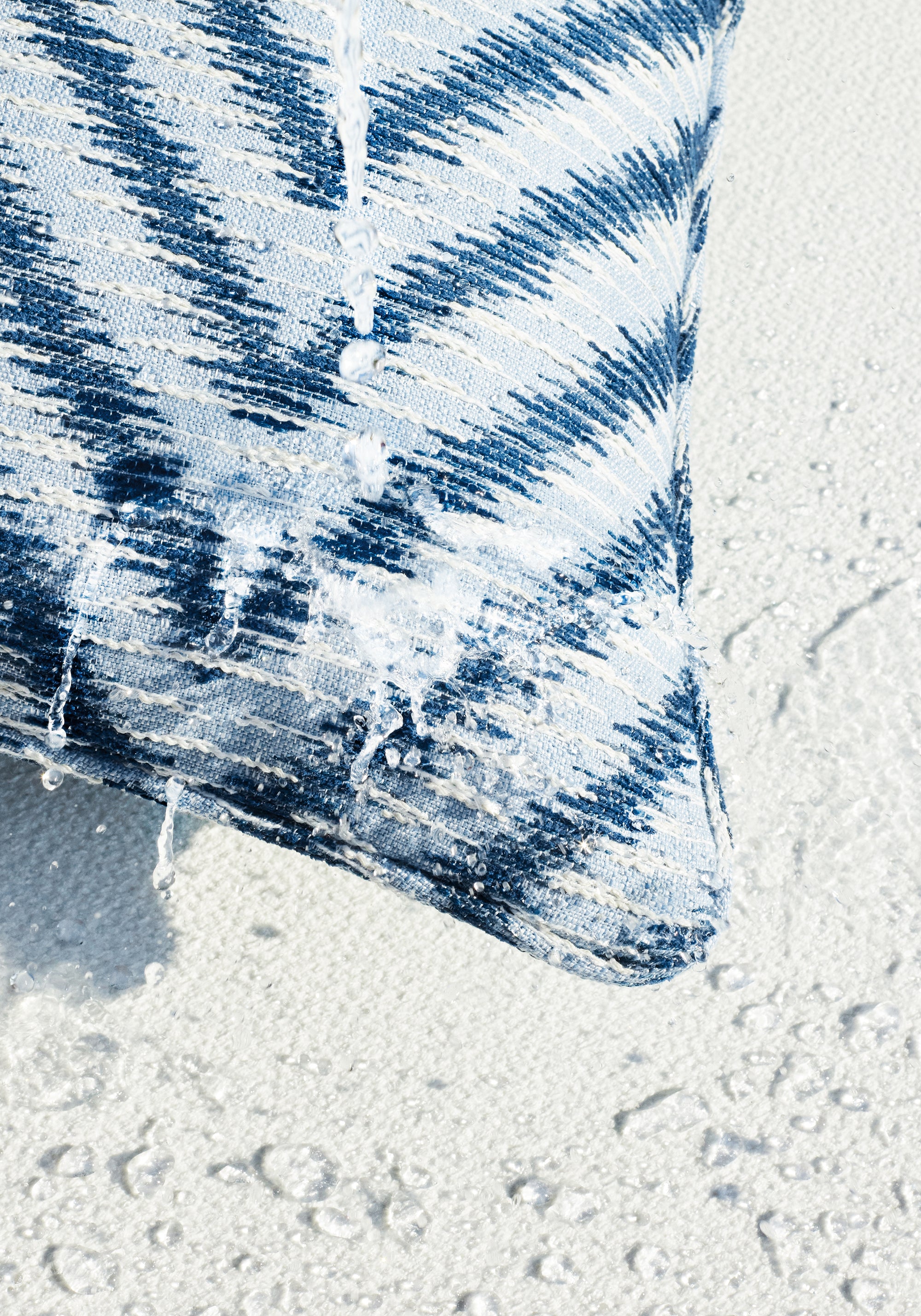 Outdoor pillow featuring Aliso fabric in denim color - pattern number W8820 - by Thibaut in the Haven collection
