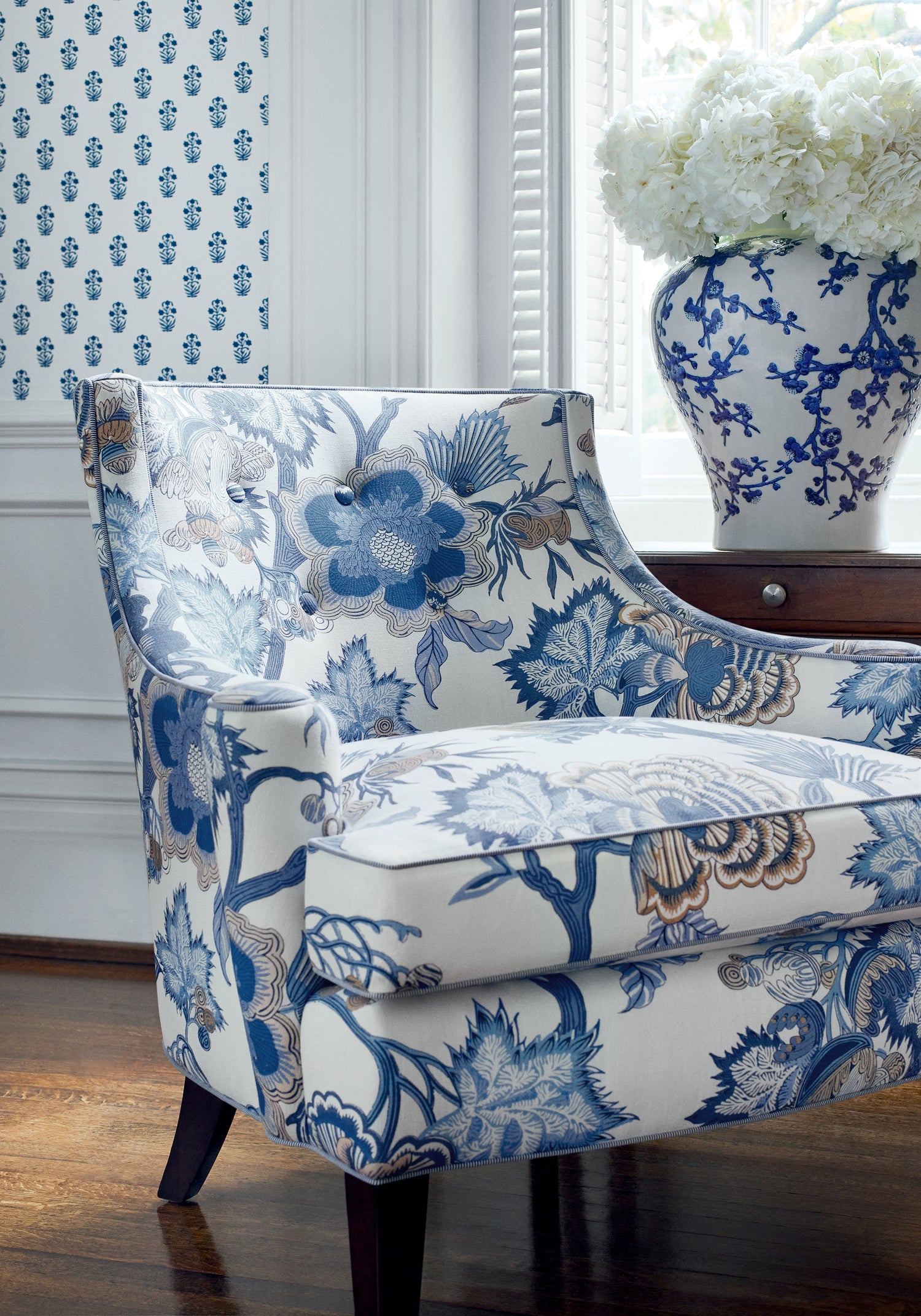 Side view of chair featuring Indienne Jacobean fabric in blue and white color - pattern number F936418 - by Thibaut in the Indienne collection