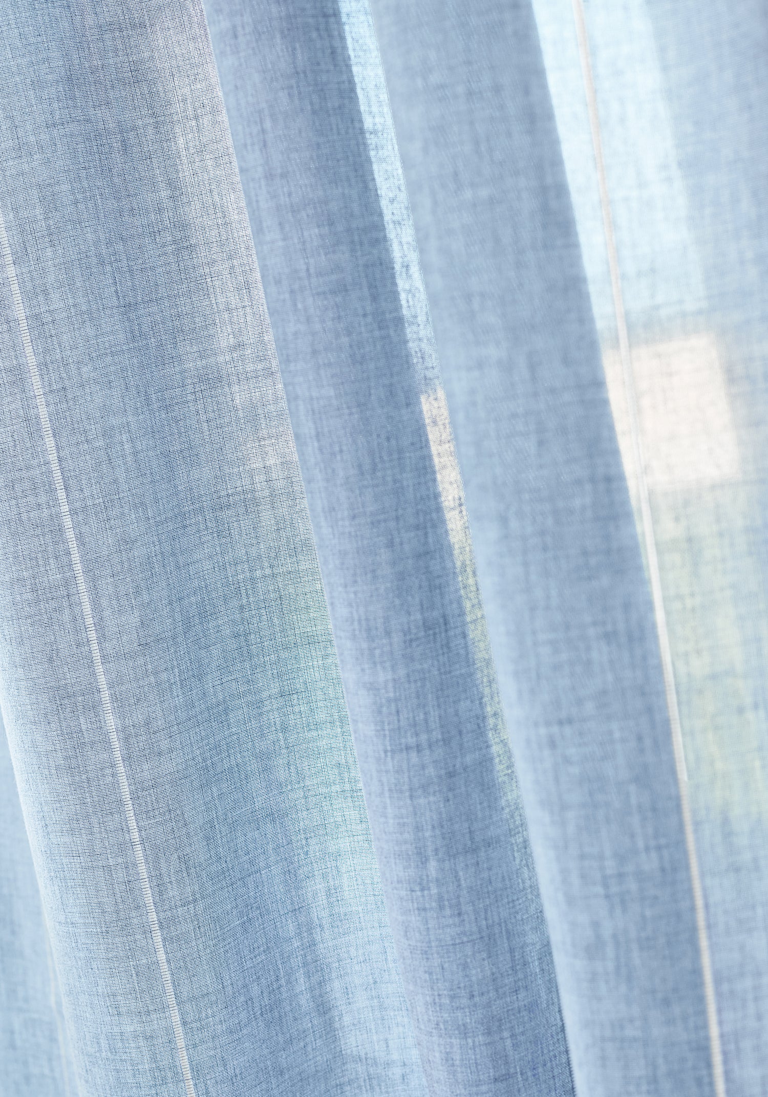 Closeup of curtains made with crestline fabric in oxford blue color - pattern number FWW81740 - by Thibaut