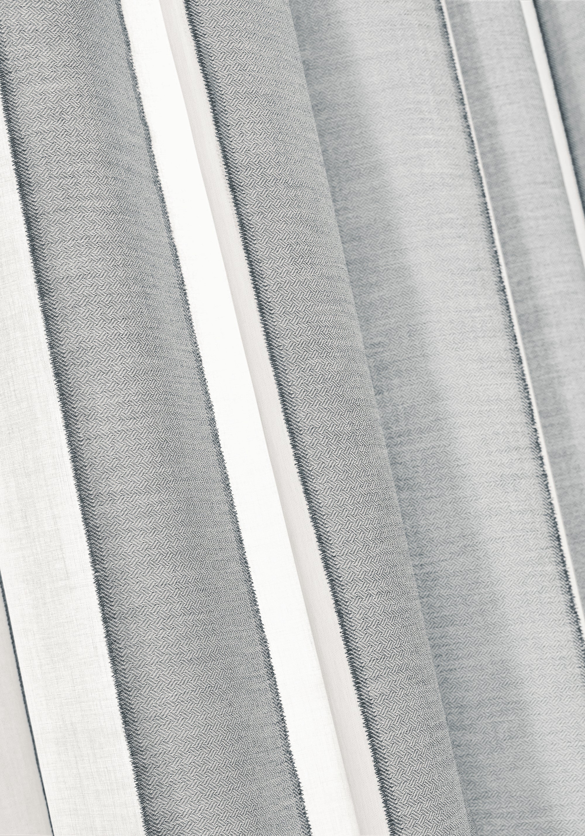 Close up of curtains made from Intaglio Stripe fabric in charcoal color - pattern number FWW81746 - by Thibaut fabrics