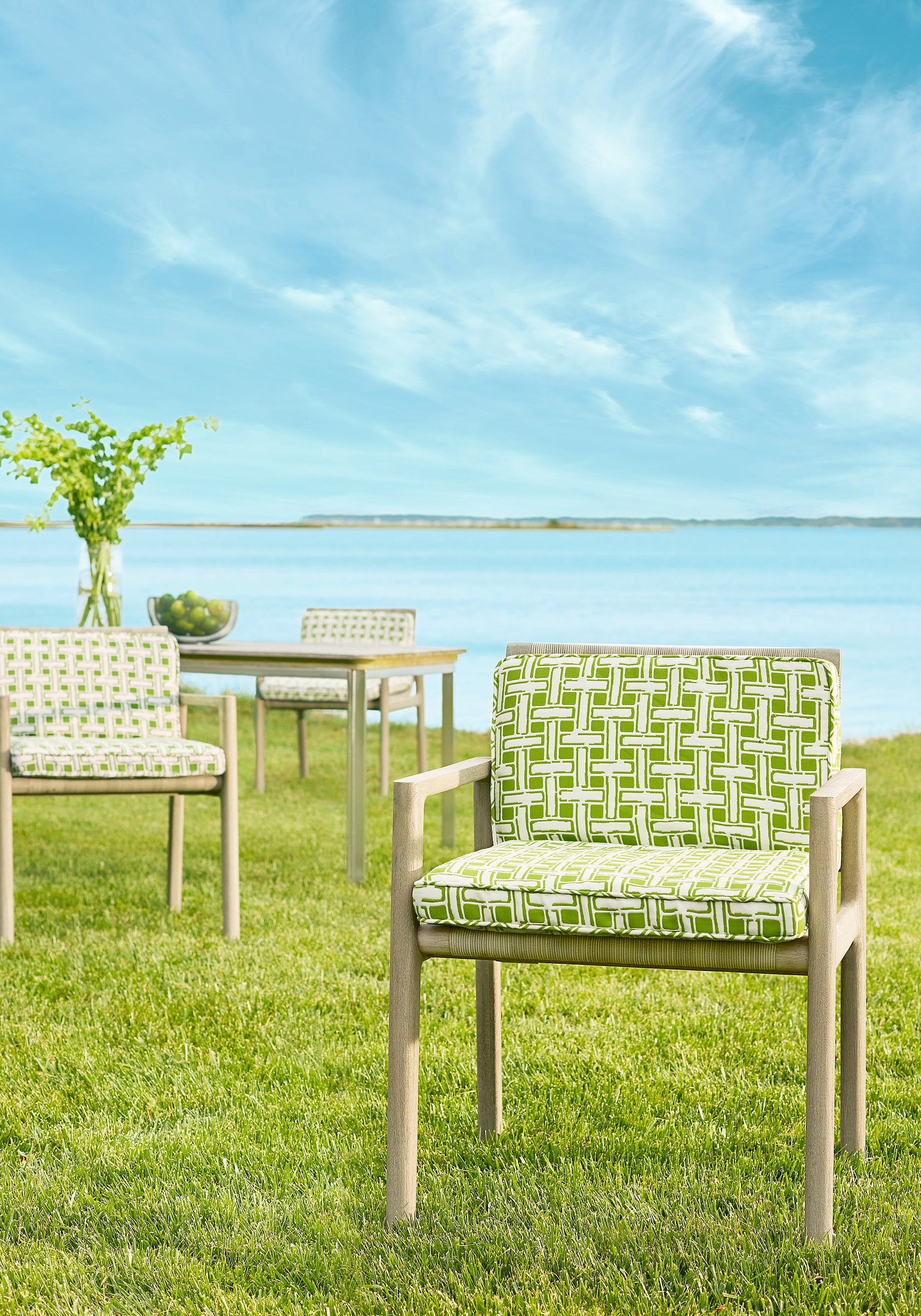 Dining chairs upholstered in Panama Matelasse outdoor fabric in kiwi color - pattern number W81640 - by Thibaut