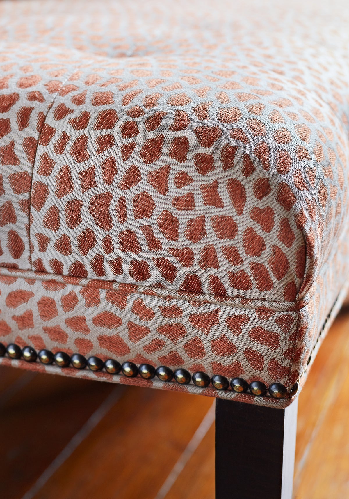 Detailed view of Westover Ottoman in Masai woven fabric in terracotta color - pattern number W80424 by Thibaut in the Woven Resource Vol 10 Menagerie collection