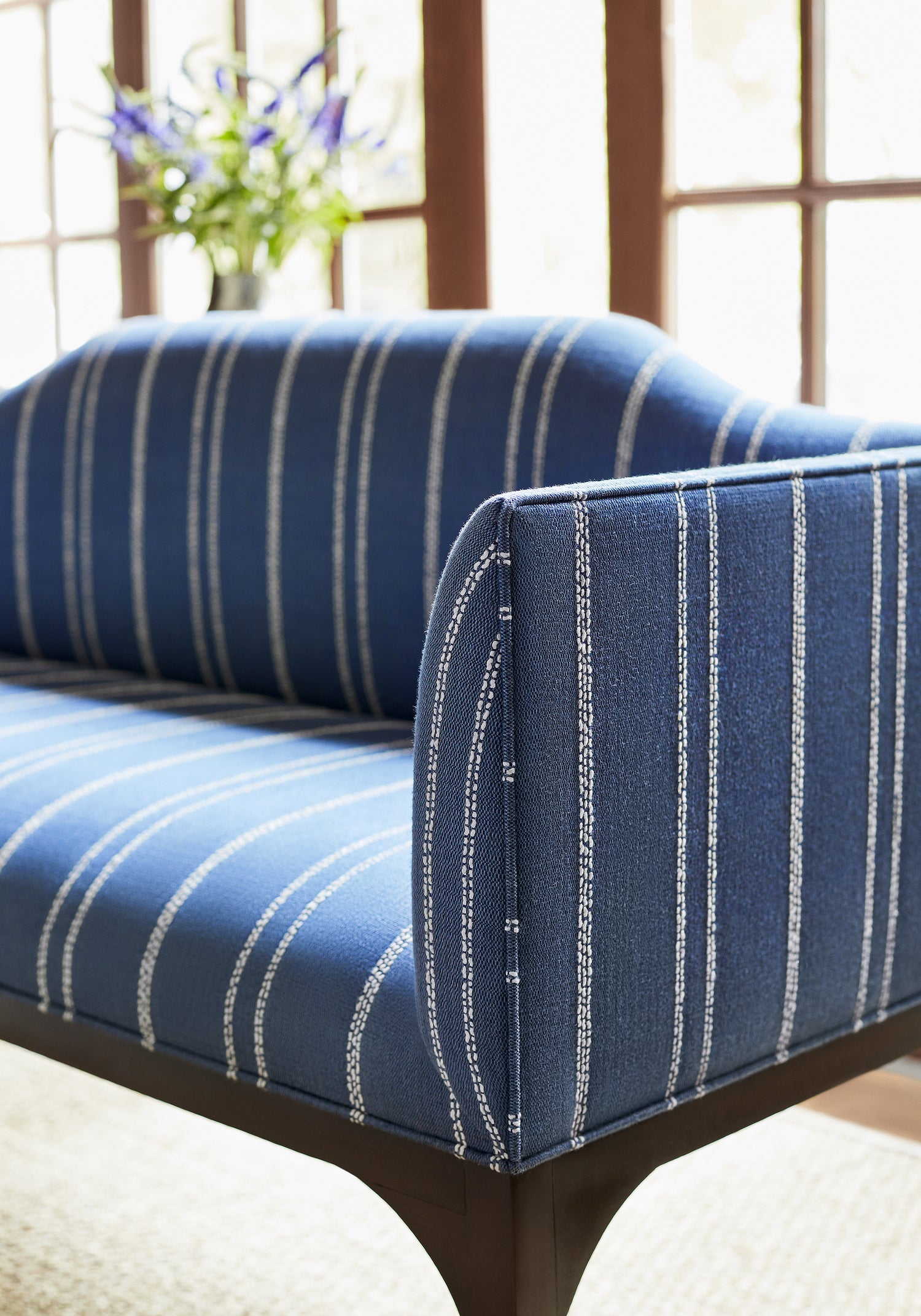 Detailed view of Dorset Bench in Nolan Stripe woven fabric in blue color variant by Thibaut in the Nomad collection - pattern number W73309