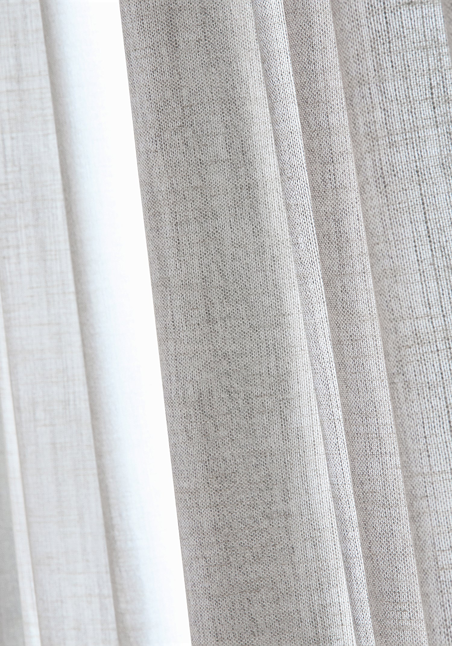 Detail of Terra Linen wide woven fabric drapes in pebble color by Thibaut as part of the Palisades collection - pattern number FWW7677