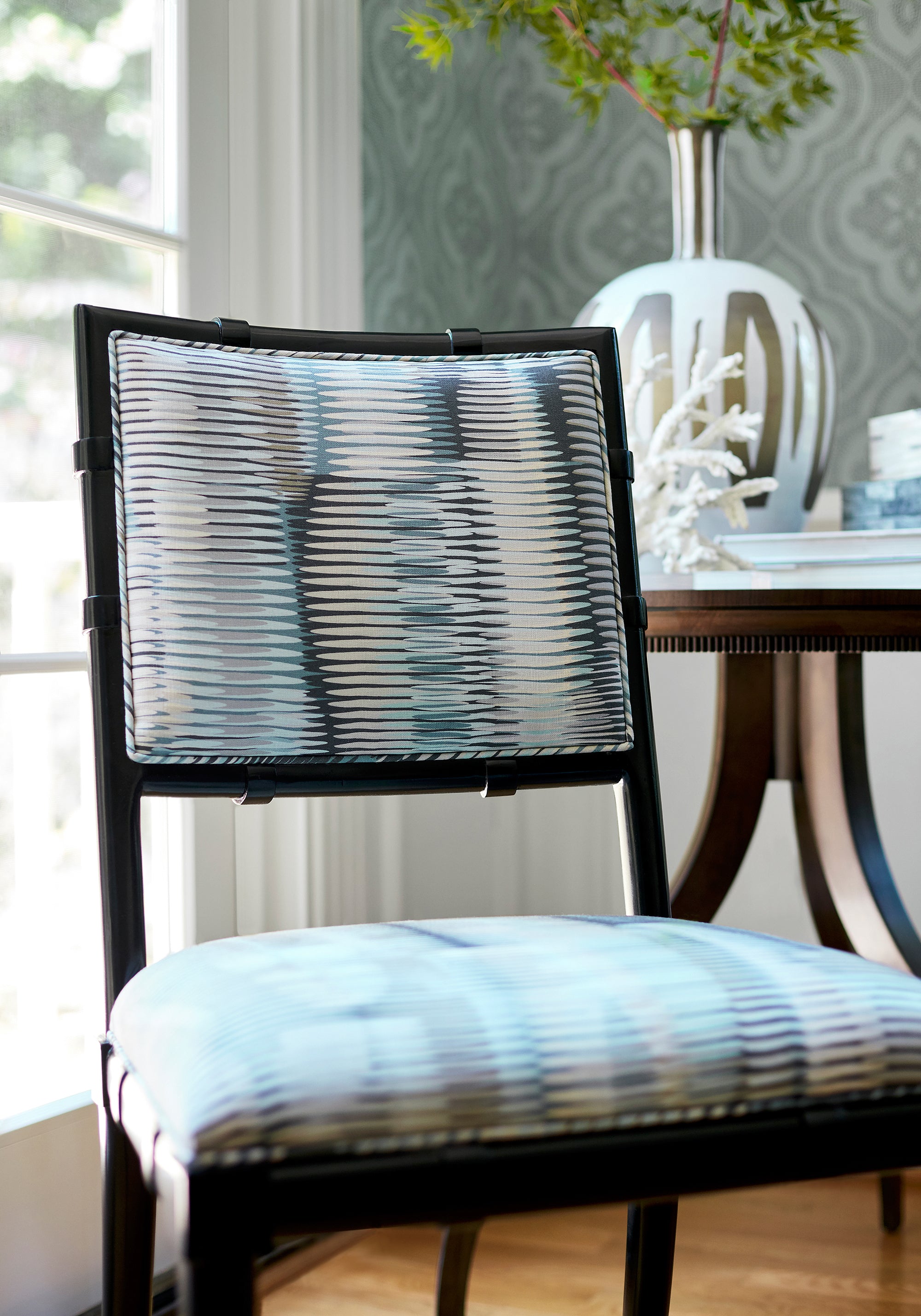 Detailed view of Greenwich Dining Chair in Alcantara printed fabric in aqua and black color variant by Thibaut in the Paramount collection - pattern number F92953