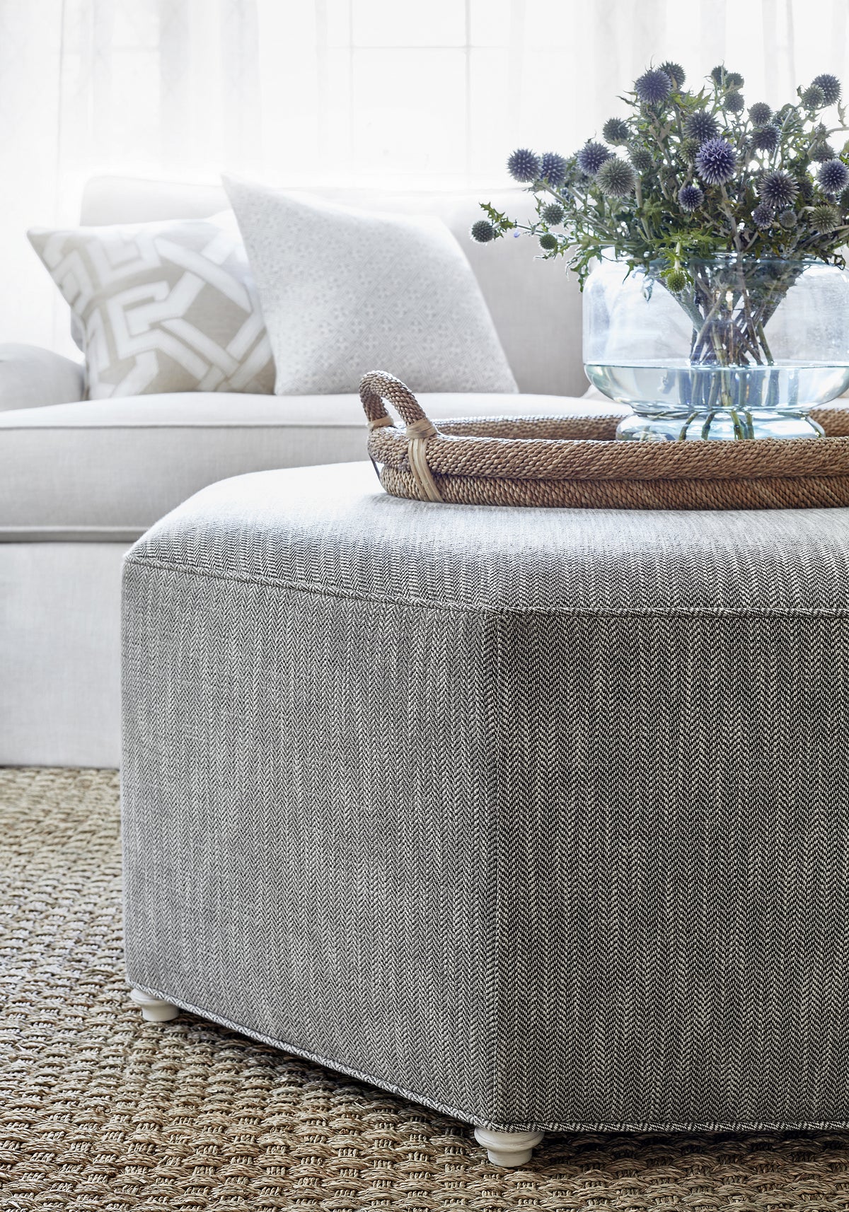 Detailed view of Octavio Ottoman in Ashbourne Tweed woven fabric in charcoal color variant by Thibaut in the Pinnacle collection - pattern number W80618