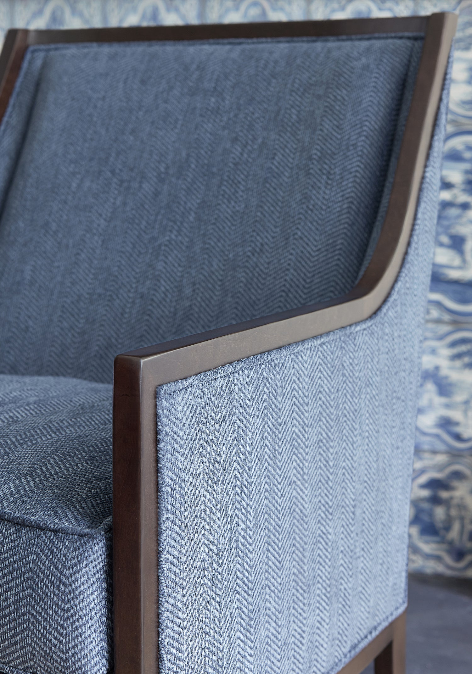 Detailed view of Pasadena Chair in Dalton Herringbone woven fabric in cadet color variant by Thibaut in the Pinnacle collection - pattern number W80626