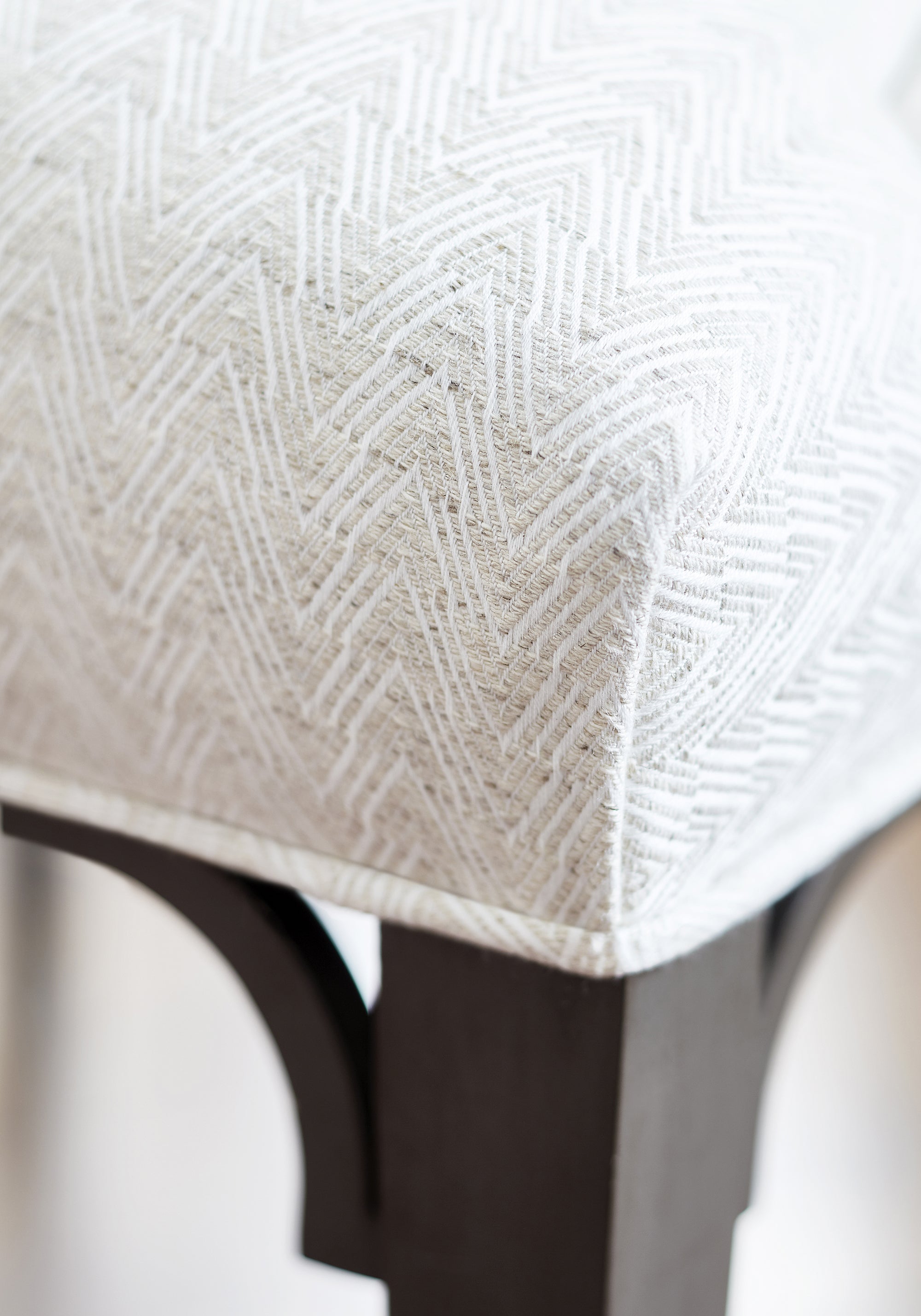 Detailed view of Bailey Dining Chair in Gatsby woven fabric in flax color variant by Thibaut in the Pinnacle collection - pattern number W80647