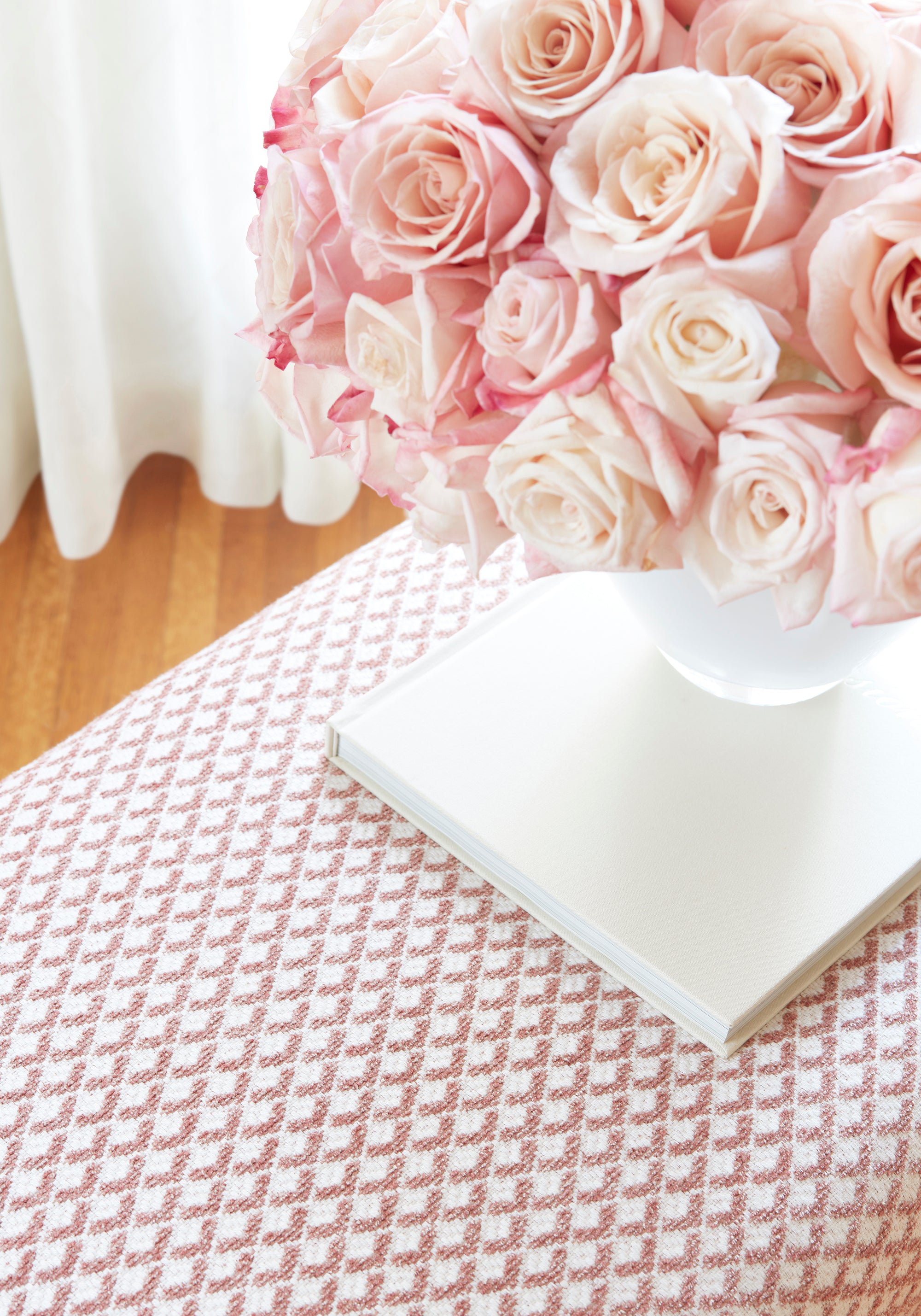 Detailed view of Bellwood Bench in Scala woven fabric in blush color with flower arrangement - pattern number W80727 by Thibaut in the Woven Resource Vol 11 Rialto collection