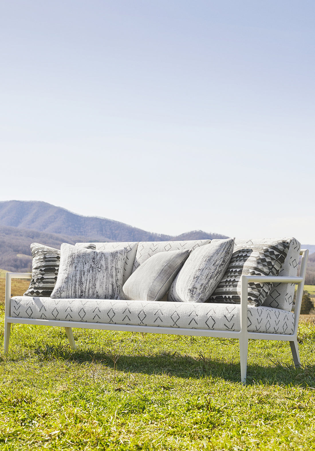 Outdoor couch upholstered in Anasazi fabric in charcoal color - pattern number W78363 - by Thibaut in the Sierra collection