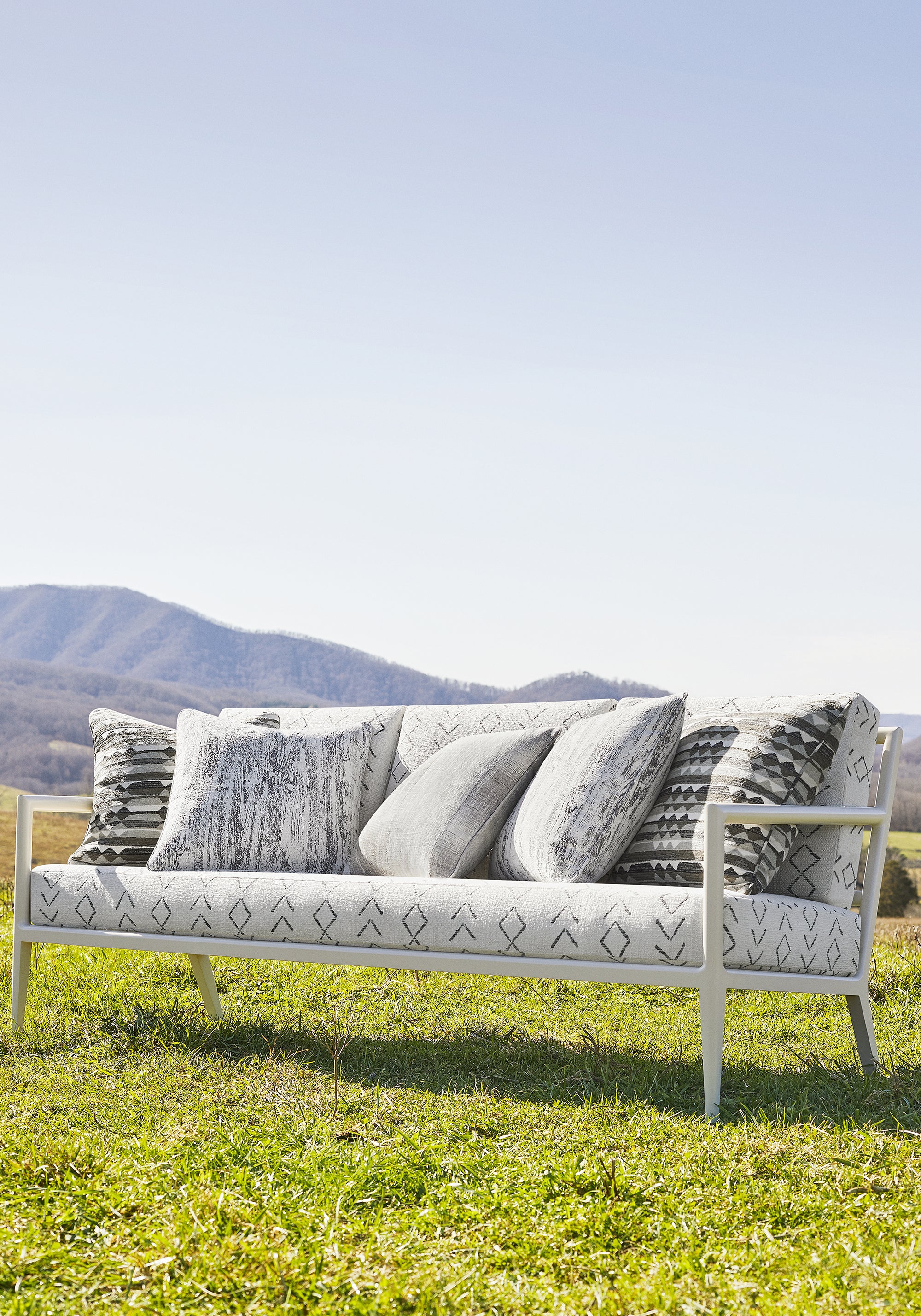 Outdoor couch upholstered in Anasazi fabric in charcoal color - pattern number W78363 - by Thibaut in the Sierra collection