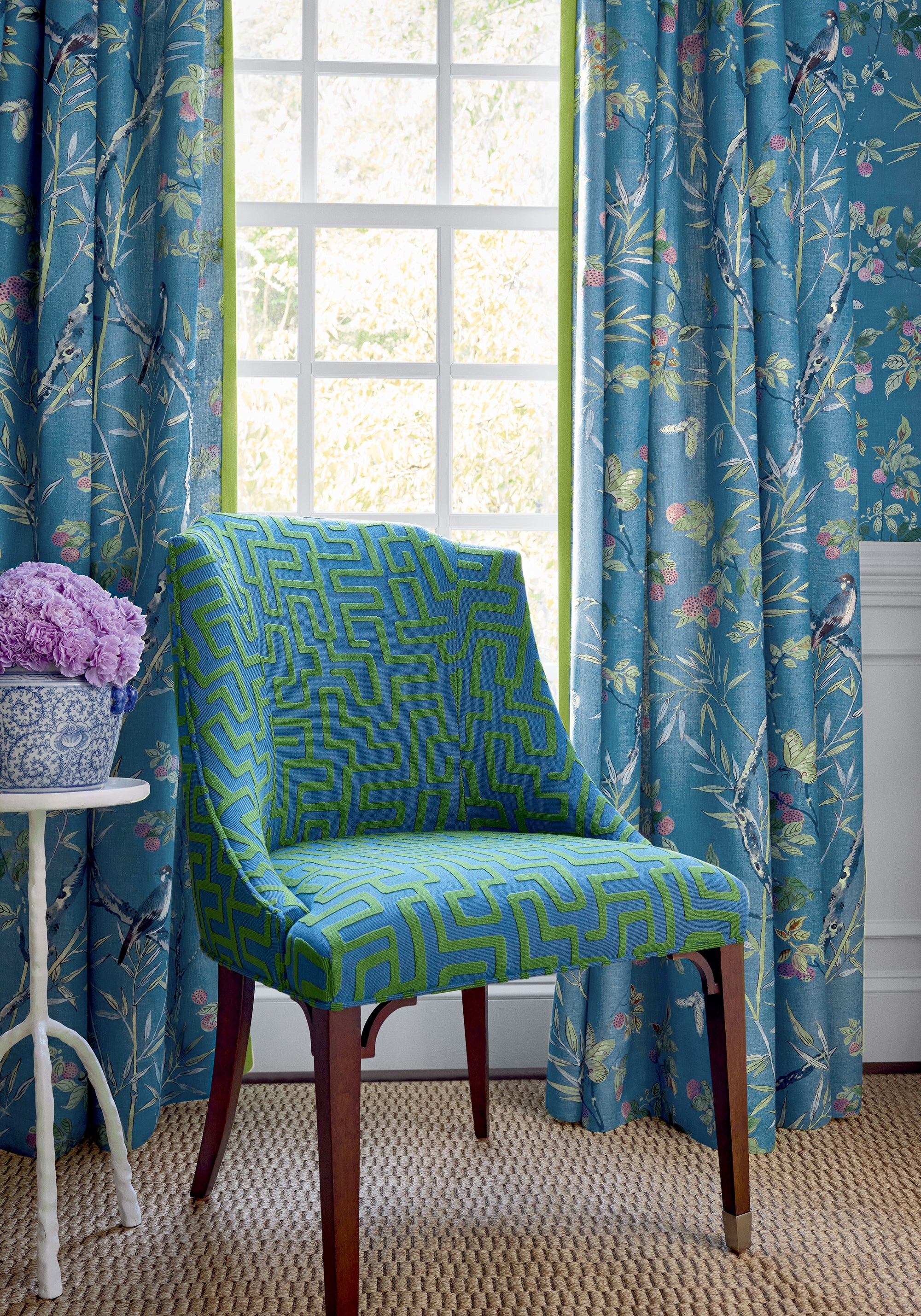 Living room with Drapery curtains made with claire printed fabric in Navy color pattern F942008 by Thibaut fabrics