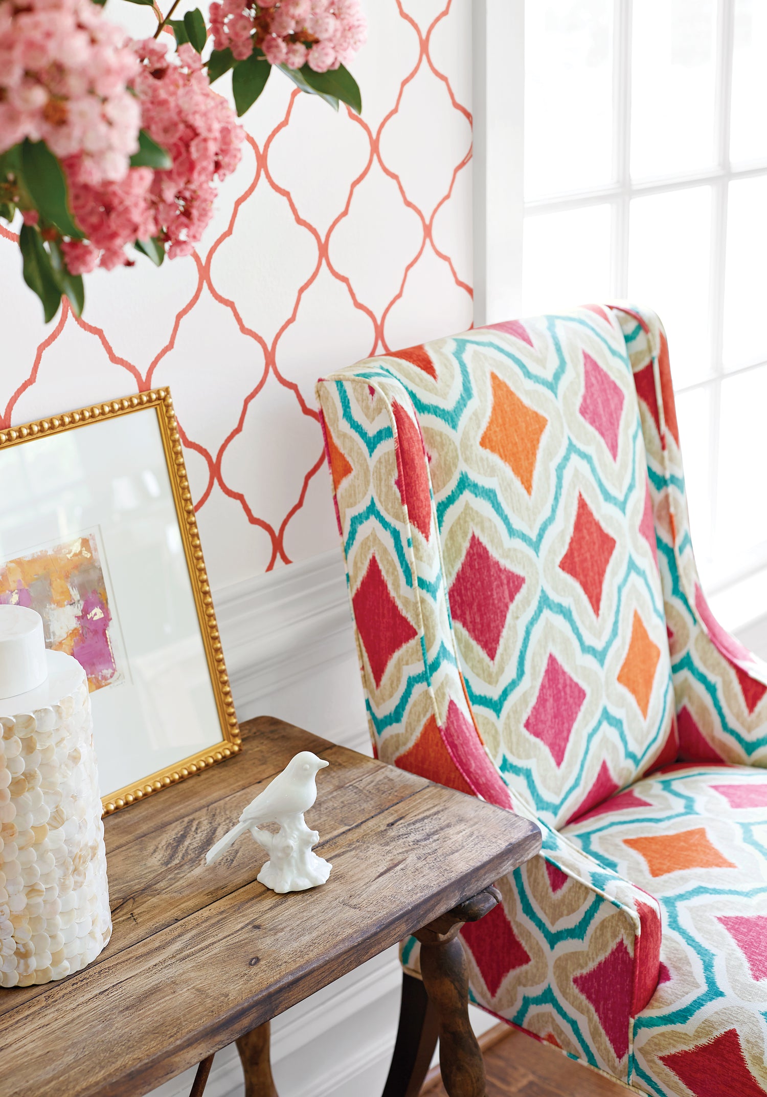 Detailed view of Hudson Chair in Cruising printed fabric in orange and pink color - pattern number F988741 by Thibaut in the Trade Routes collection