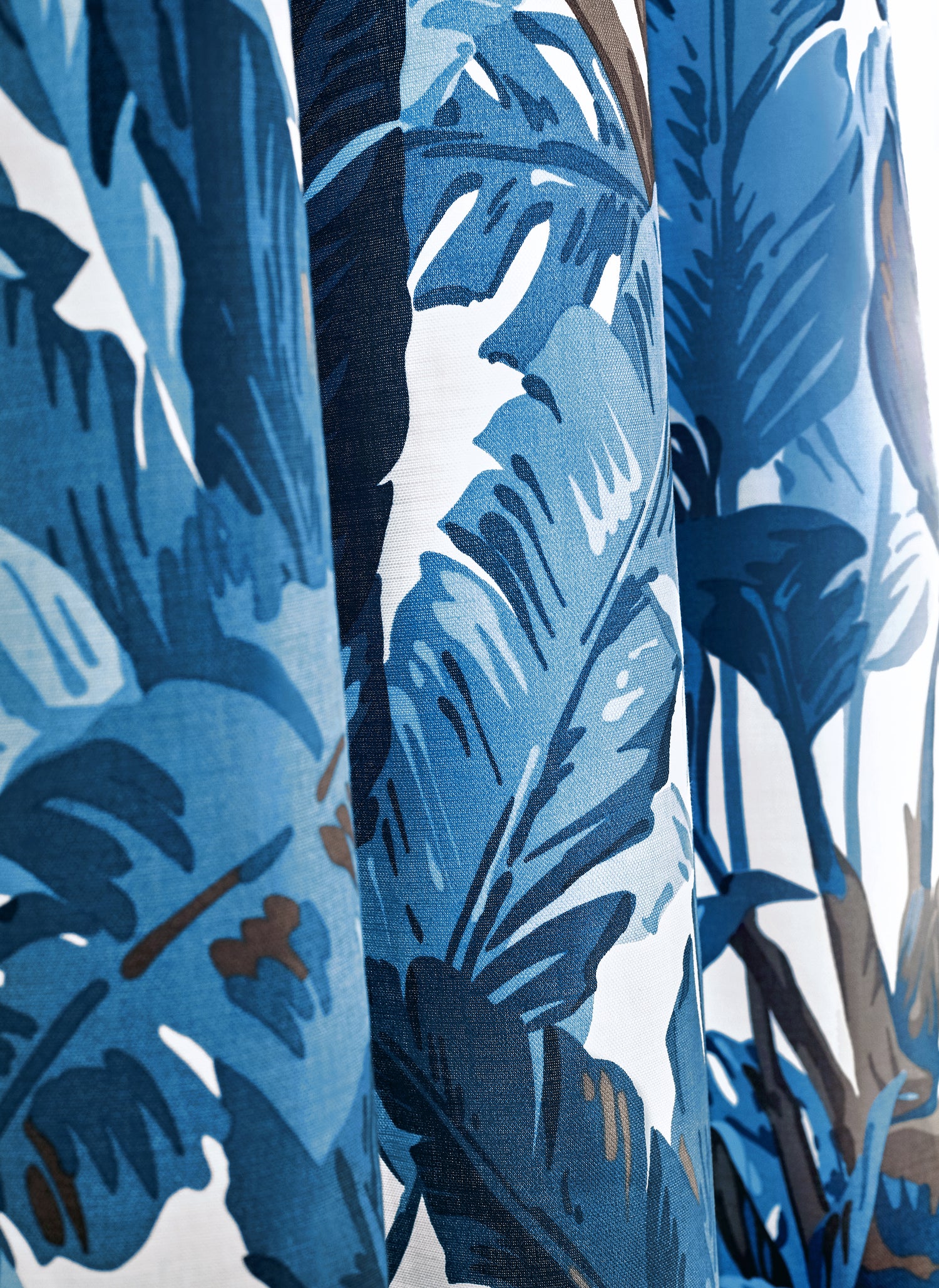 Detail of Travelers Palm printed fabric in navy and white color by Thibaut as part of the Tropics collection - pattern number F910126